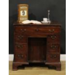 A George III mahogany kneehole desk, slightly oversailing top with moulded edge above a slide and