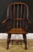 A 19th century beech, ash and elm child’s Windsor elbow chair, 74cm high, 47cm wide