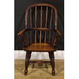 A 19th century beech, ash and elm child’s Windsor elbow chair, 74cm high, 47cm wide