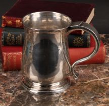 A George II West Country provincial silver bell shaped beer mug, scroll handle, skirted base, 12cm