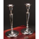 A pair of George III silver table candlesticks, detachable nozzles, fluted bell shaped sconces and