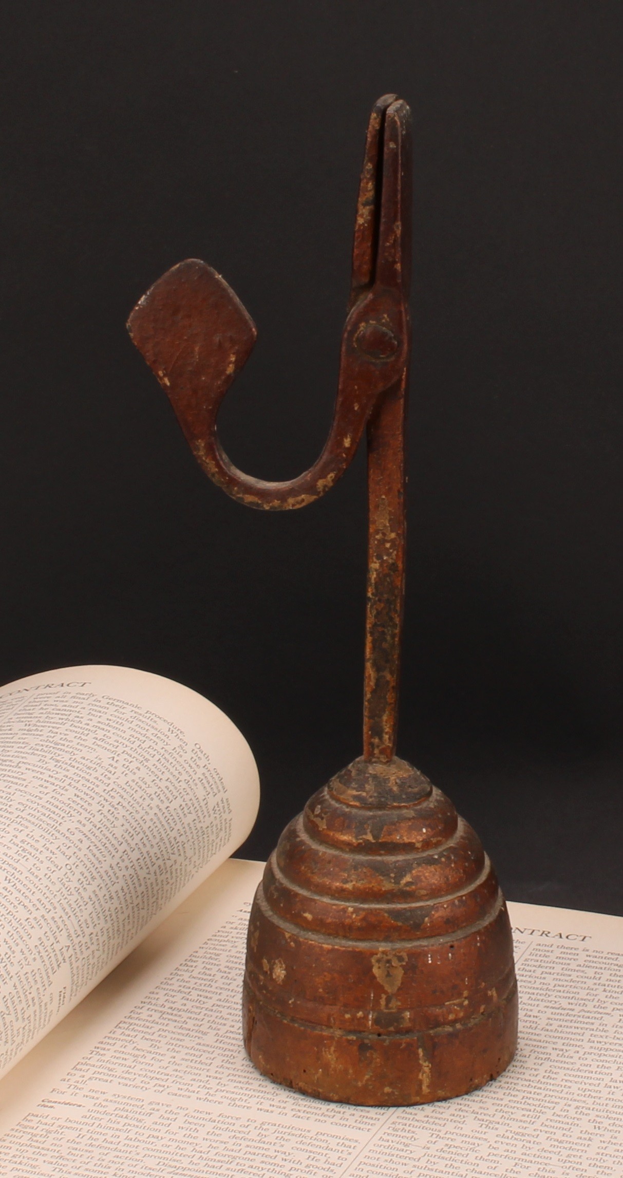 A wrought iron nip rushlight holder, stepped circular wood base, 27cm high, 18th/19th century
