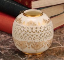 A Royal Worcester ovoid reticulated vase, by George Owen, outlined with gilt bands of scrolls and