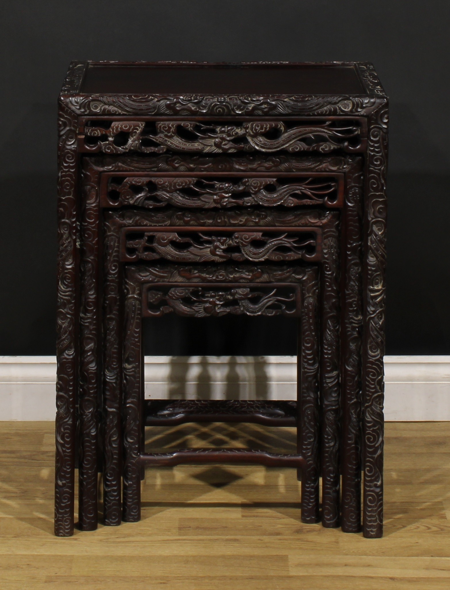 A set of Chinese hardwood quartetto tables, each carved throughout with dragons, the largest 70. - Image 3 of 6