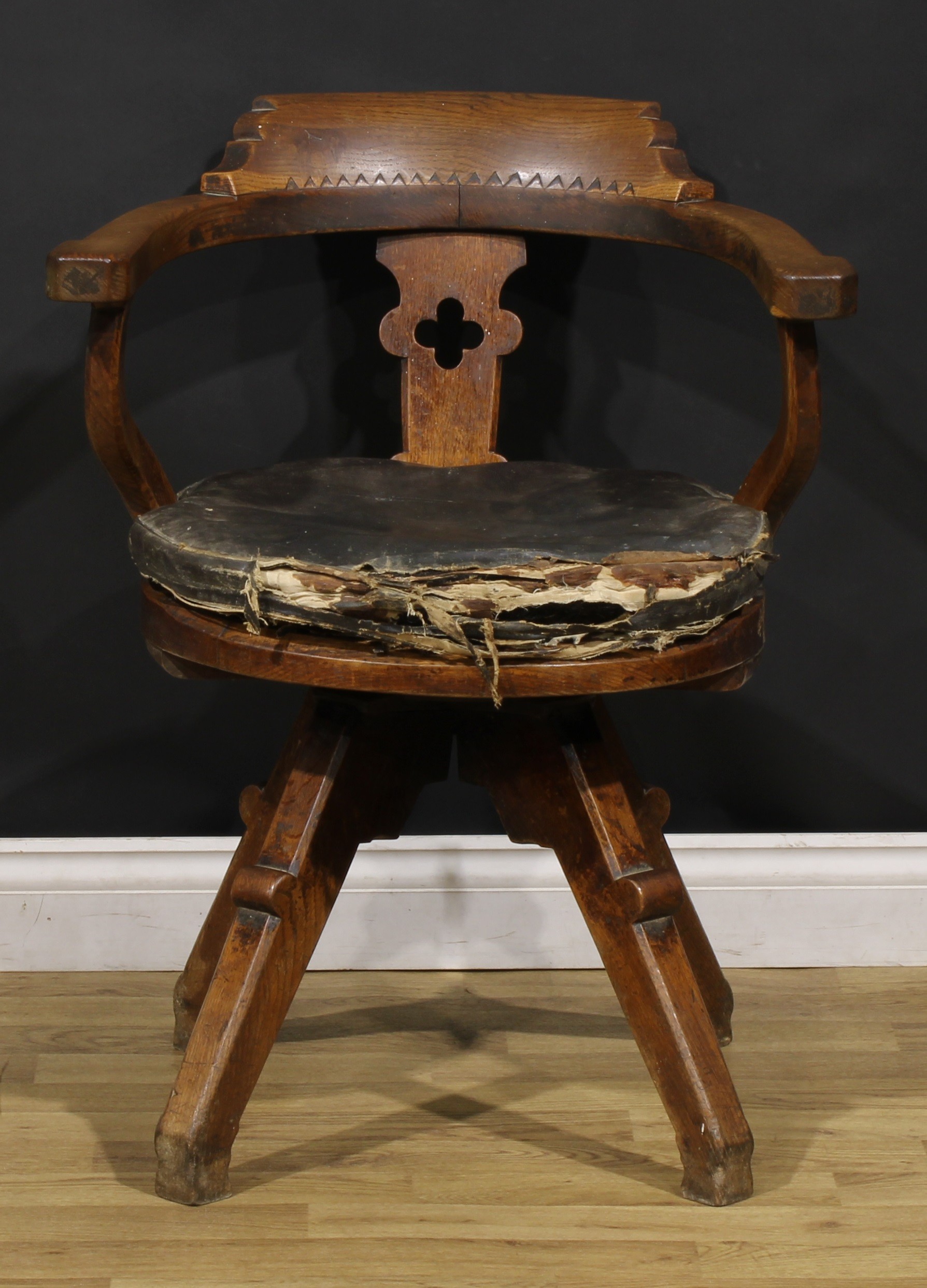 An Arts & Crafts oak swivel desk chair, possibly James Shoolbred and Co, 79.5cm high, 62.5cm wide,