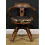 An Arts & Crafts oak swivel desk chair, possibly James Shoolbred and Co, 79.5cm high, 62.5cm wide,