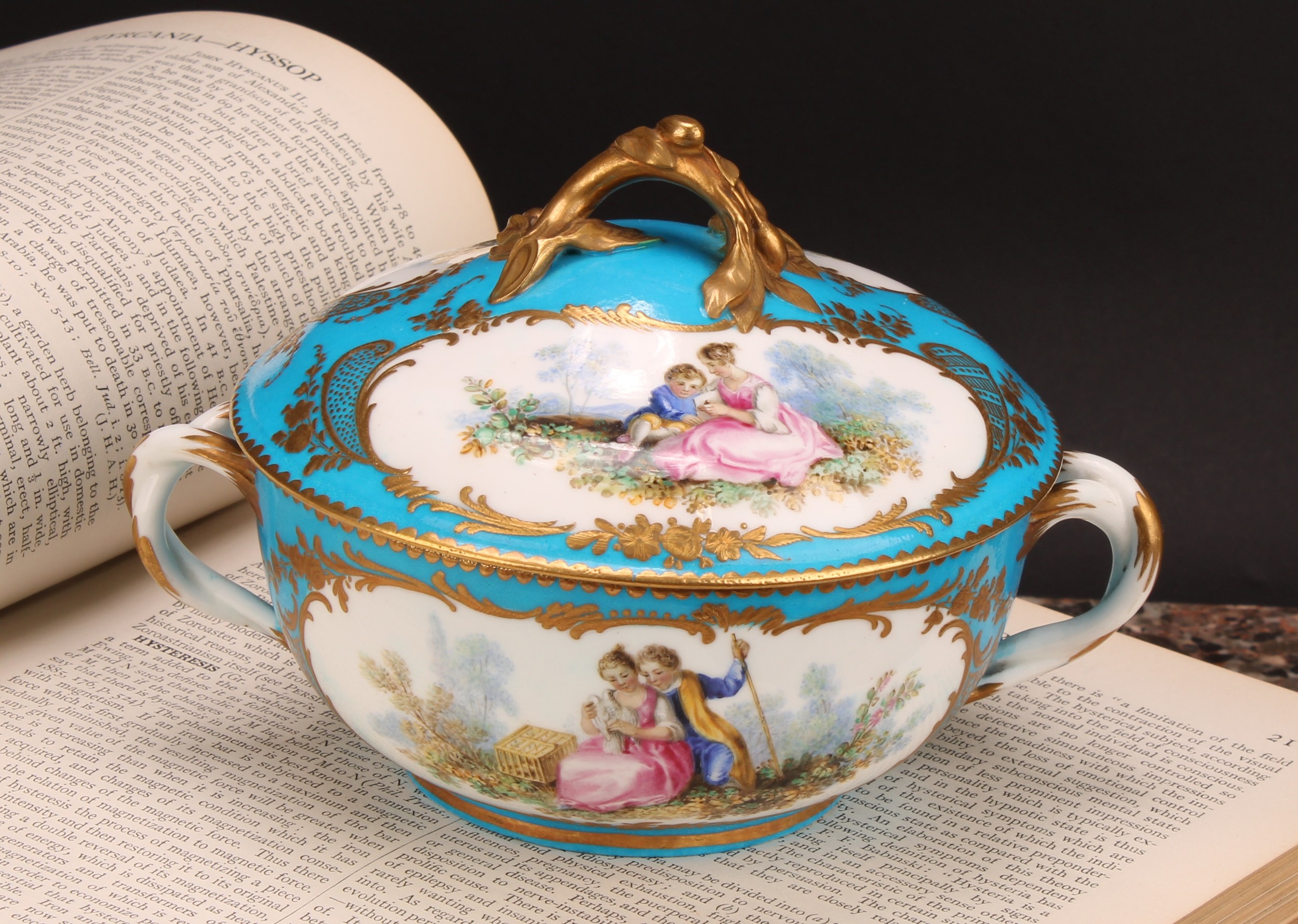 A Continental porcelain eculle and cover, painted with courting couples in a pastoral idyl, within