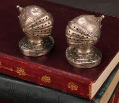 A pair of Victorian Gothic Revival silver novelty peppers, each as a knight's helmet and visor,