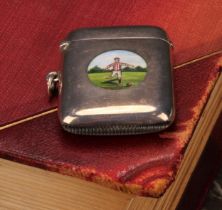 An George V silver and enamel rounded rectangular vesta case, decorated with an circular reserve