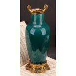 An early 20th century ormolu mounted monochrome vase, glazed in streaked tones of mottled turquoise,