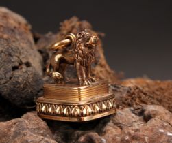 A 19th century gold coloured metal fob seal, surmounted with a lion, lotus border, the citrine