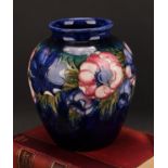 A Moorcroft Anemone pattern ovoid vase, tube lined with bold flower heads on a cobalt blue ground,