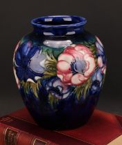 A Moorcroft Anemone pattern ovoid vase, tube lined with bold flower heads on a cobalt blue ground,