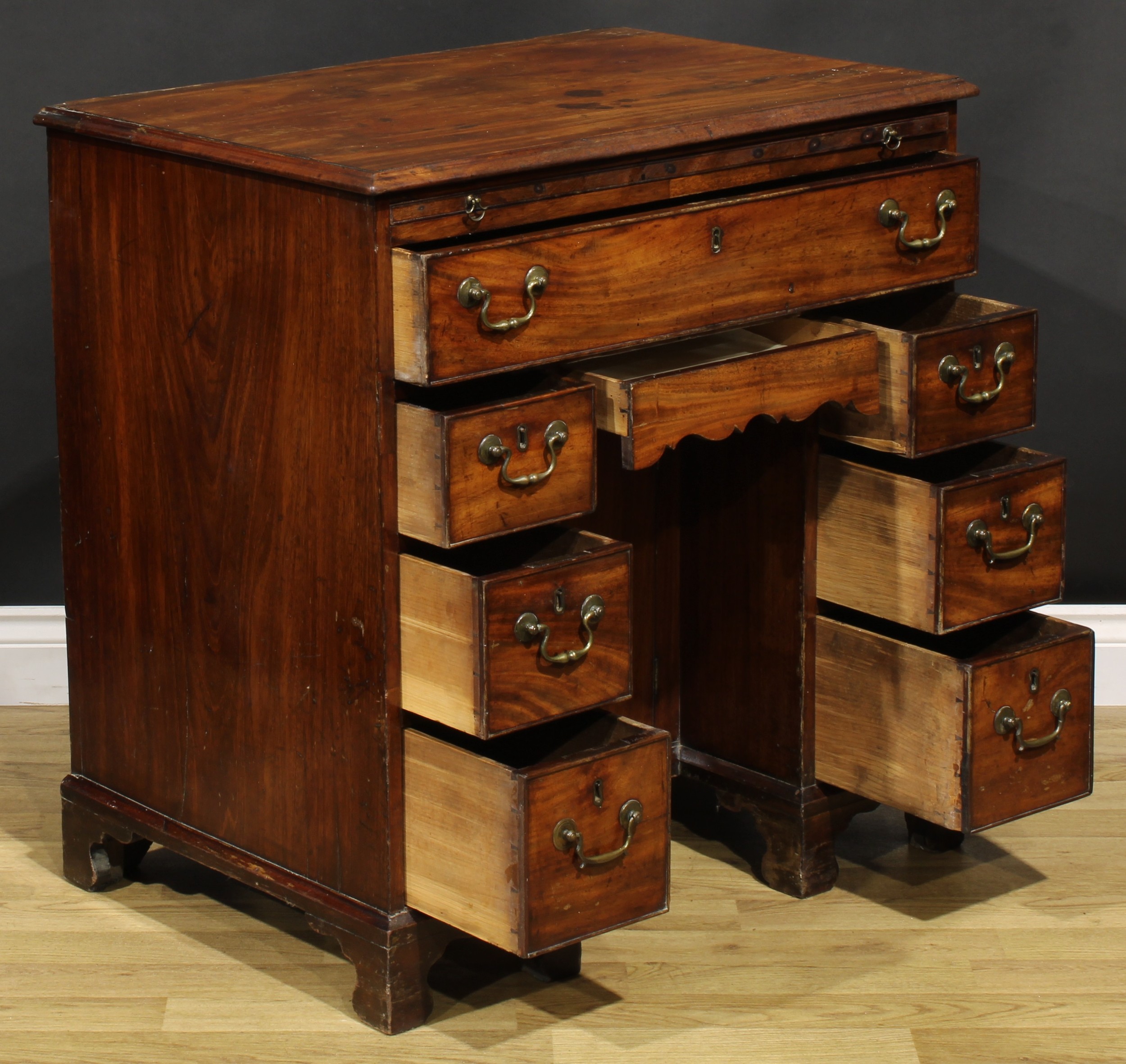 A George III mahogany kneehole desk, the ovolu moulded top above a brushing slide, axe head handles, - Image 6 of 8