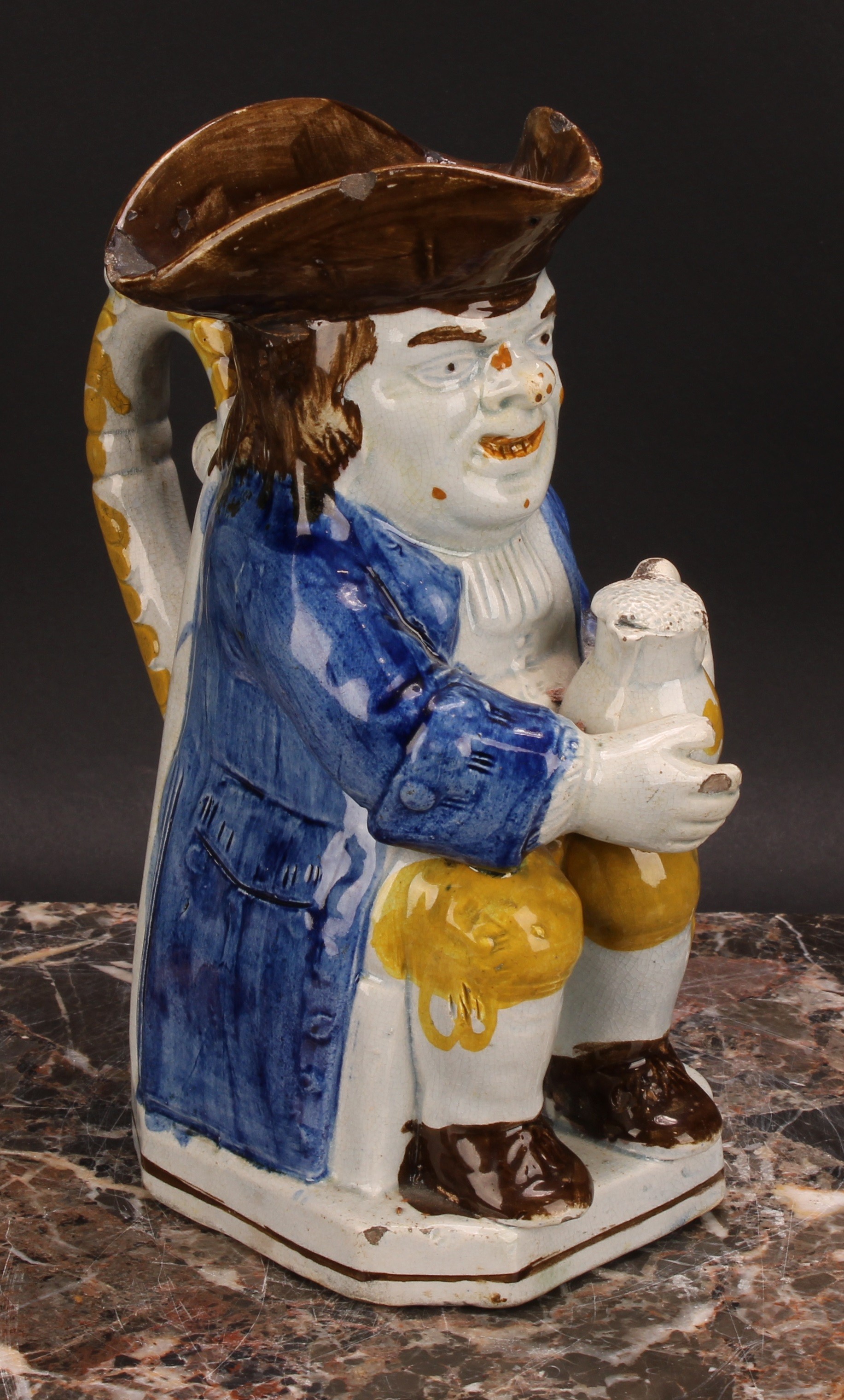 An early 19th century Prattware Toby jug, seated holding a jug of foaming ale, painted in polychrome - Image 2 of 5