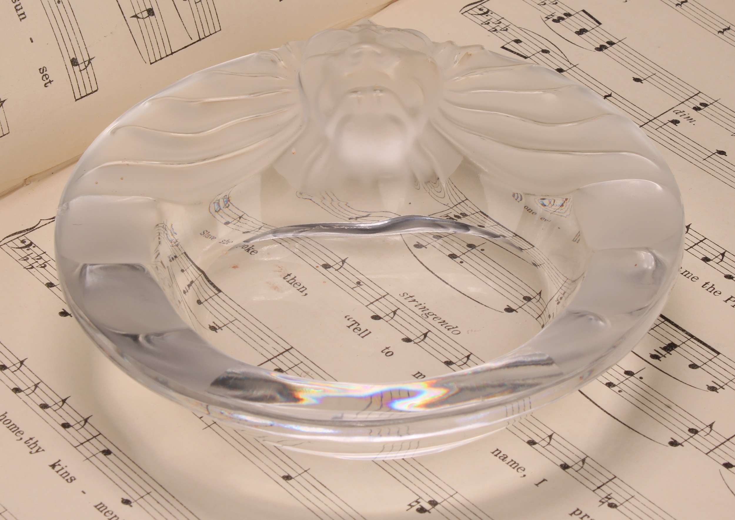 A Lalique Tete de Lion circular glass dish, the rim with frosted stylised lion mask with spreading