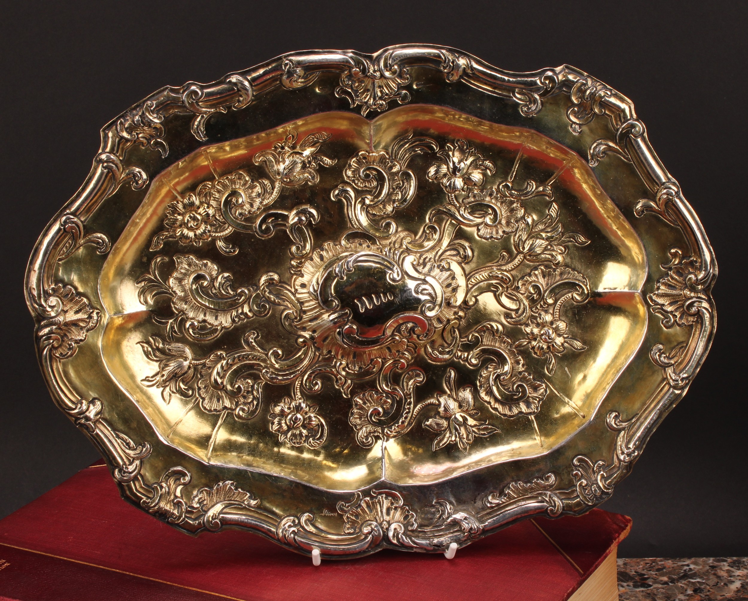 An 18th century Spanish silver-gilt shaped oval sideboard dish, chased with flowers and leafy