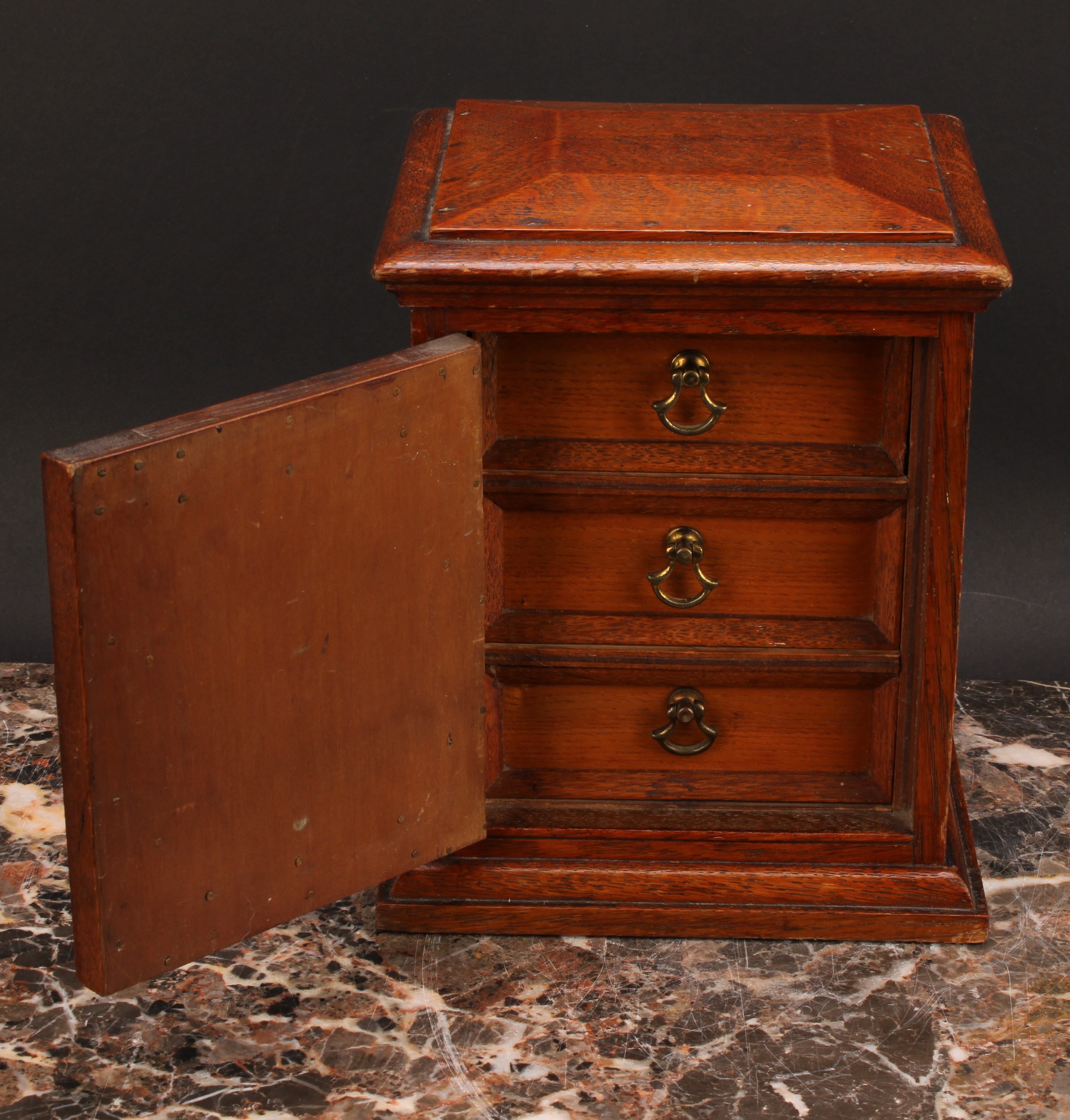 A Victorian oak table top cabinet, sarcophagus top above a panelled door enclosing three collector's - Image 3 of 5