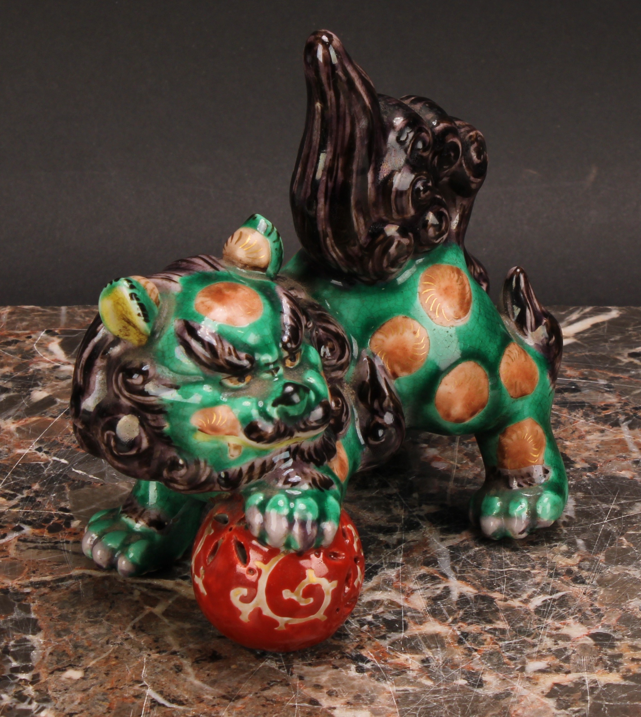 A Japanese porcelain model, of a temple lion, glazed in monochrome tones, 12.5cm wide, lacquer - Image 3 of 5