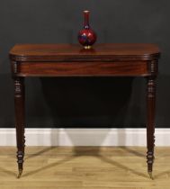 A George III mahogany tea table, hinged top with channelled edge, tapered reeded legs, brass