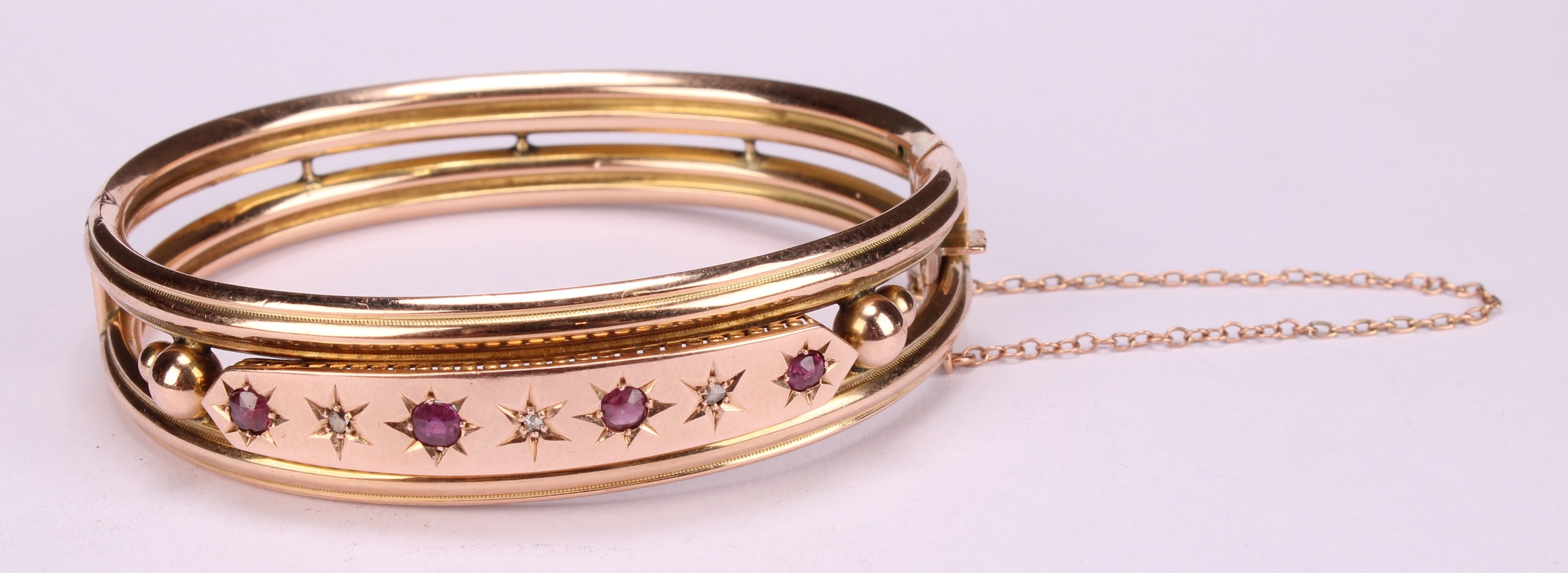 An Edwardian ruby and diamond 9ct gold hinge bangle, set with four old cut pinky red rubies, each - Image 2 of 5
