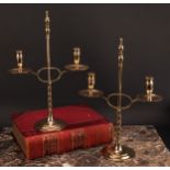 A pair of early 20th century brass two-light adjustable candelabra, orb-and-knop finiasls, broad