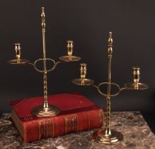A pair of early 20th century brass two-light adjustable candelabra, orb-and-knop finiasls, broad