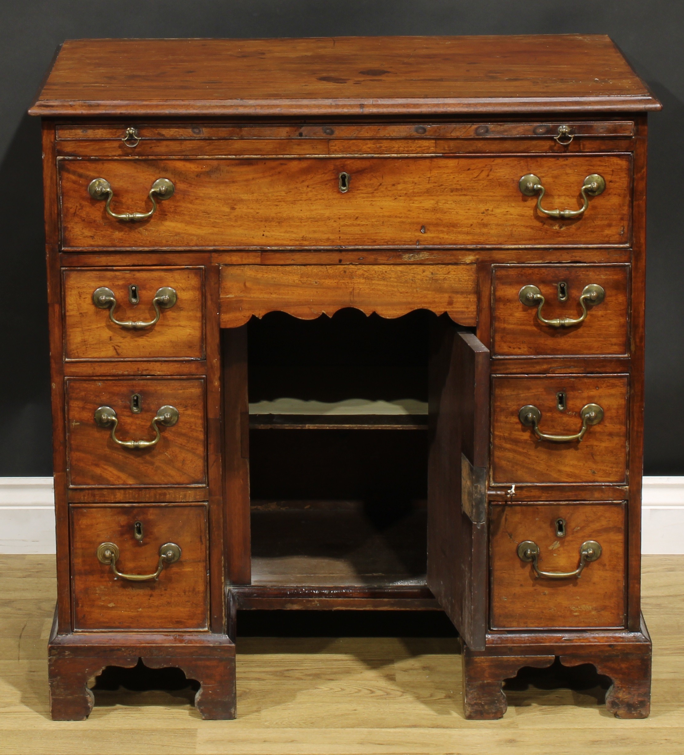 A George III mahogany kneehole desk, the ovolu moulded top above a brushing slide, axe head handles, - Image 4 of 8
