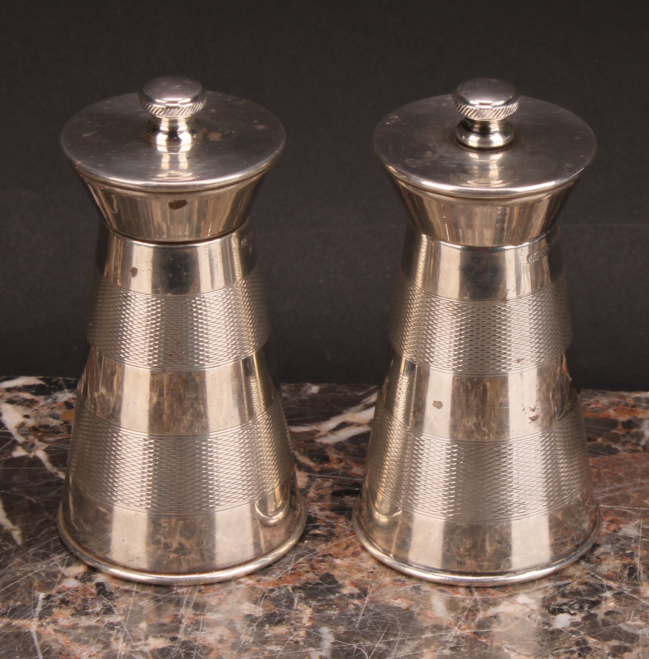 A pair of Art Deco style silver spreading cylindrical pepper mills of grinders, each engine turned - Image 2 of 6