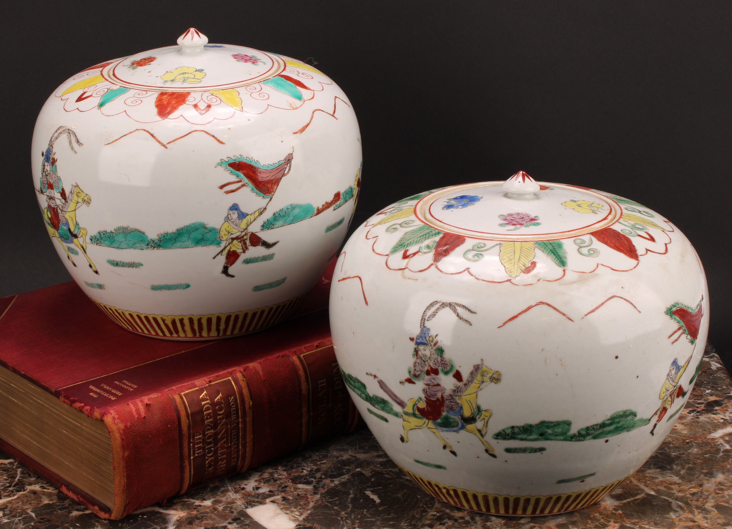 A pair of Chinese ovoid ginger jars and covers, decorated in polychrome with figures in battle, four