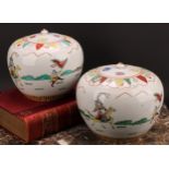 A pair of Chinese ovoid ginger jars and covers, decorated in polychrome with figures in battle, four