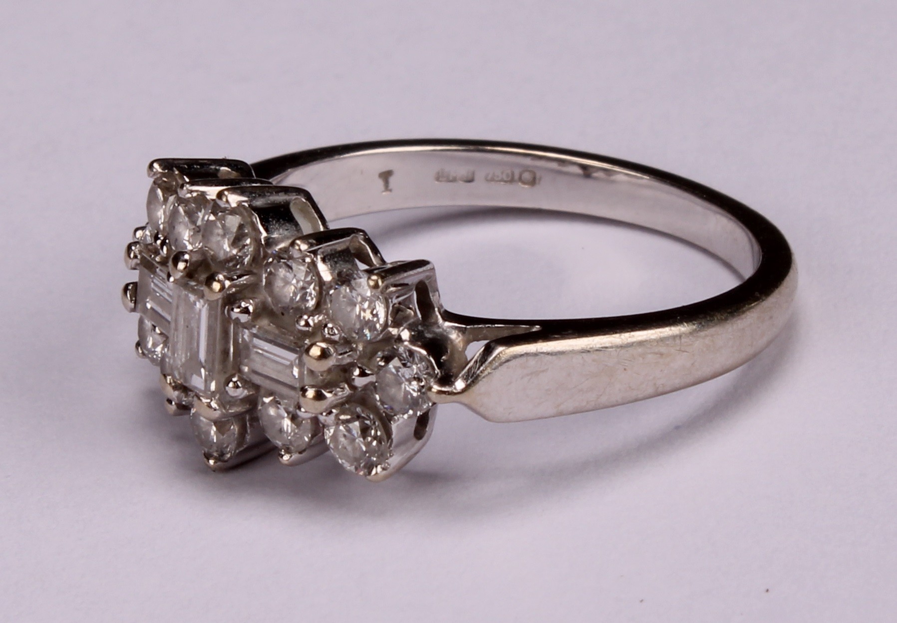 An 18k white gold diamond ring, set with three central baguette cut stones, flanked with twelve - Image 3 of 4