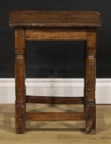 An 18th century oak joint stool, oversailing top above a deep frieze, turned legs, plain stretchers,