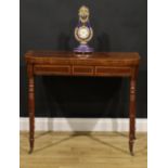 A Regency mahogany card table, hinged satinwood and rosewood crossbanded top enclosing a baize lined
