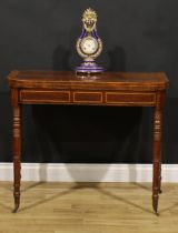 A Regency mahogany card table, hinged satinwood and rosewood crossbanded top enclosing a baize lined