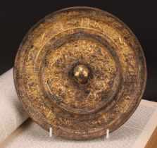 A Chinese gilt bronze mirror, cast in the Archaic taste, 21.5cm diam