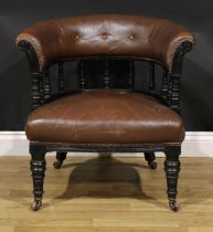 A late Victorian ebonised club or library chair, stuffed-over upholstery, turned forelegs, 69cm