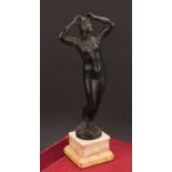 A late 19th century Grand Tour patinated bronze, of a classical female nude, rectangular stepped