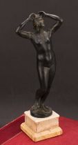 A late 19th century Grand Tour patinated bronze, of a classical female nude, rectangular stepped