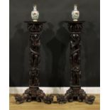 A pair of Indo-Chinese entrance hall torchères or statuary pedestals, each with a square plateau