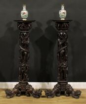 A pair of Indo-Chinese entrance hall torchères or statuary pedestals, each with a square plateau