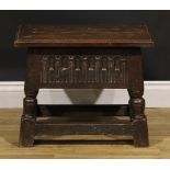 A Charles II style oak box stool, hinged top above a stop-nulled frieze, 43.5cm high, 54cm wide,