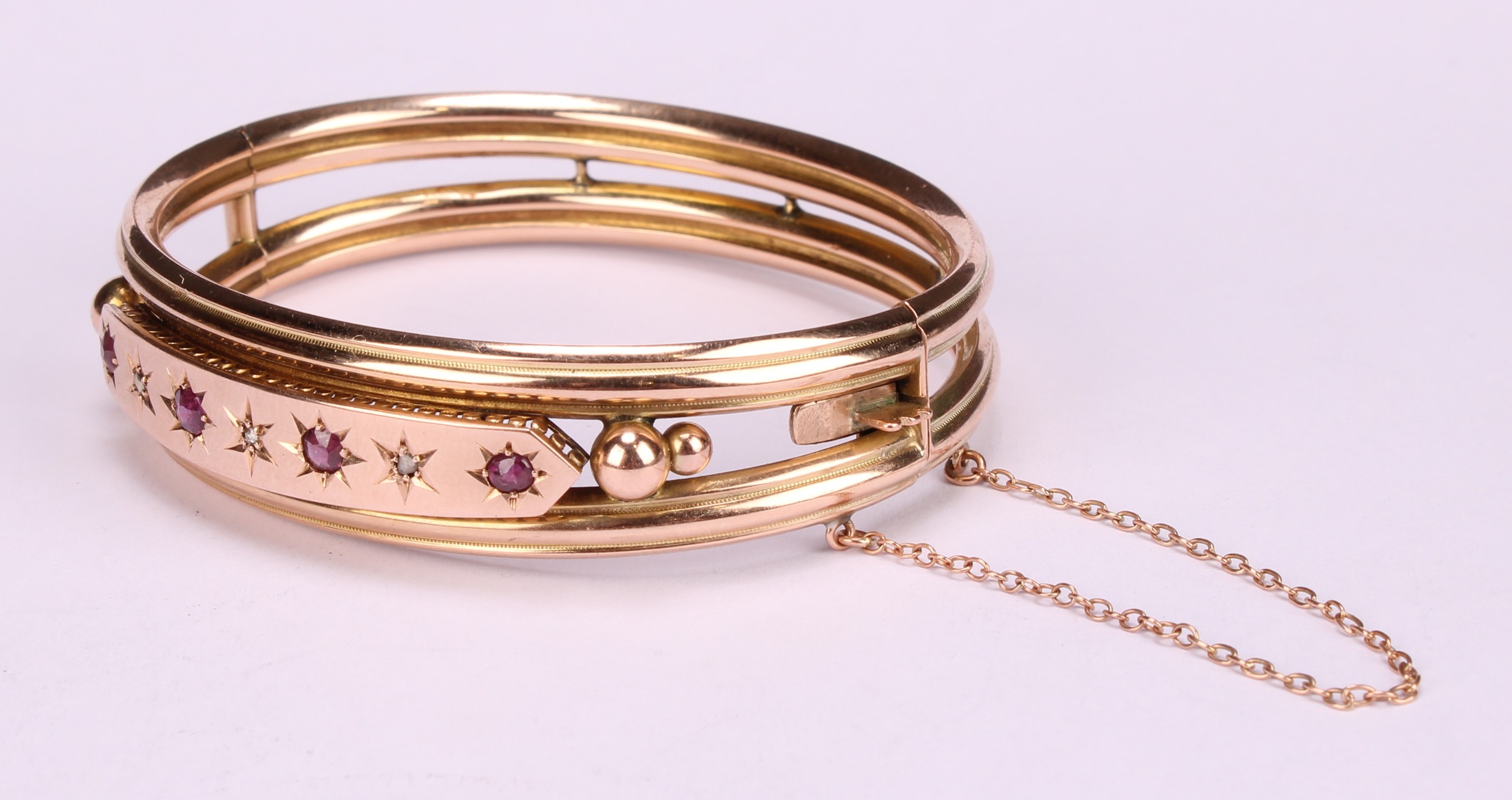 An Edwardian ruby and diamond 9ct gold hinge bangle, set with four old cut pinky red rubies, each - Image 4 of 5