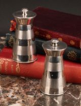 A pair of Art Deco style silver spreading cylindrical pepper mills of grinders, each engine turned