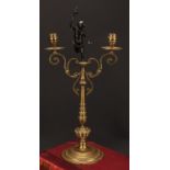 A 19th century dark patinated bronze mounted two-branch candelabrum, centred by a scantily clad