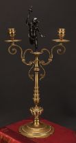 A 19th century dark patinated bronze mounted two-branch candelabrum, centred by a scantily clad