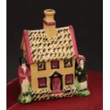 A Yorkshire Prattware polychrome spongeware cottage money box, moulded in relief with a figure to