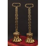 A pair of 19th century brass door stops, each cast as a lions paw, posted handles, lead-weighted