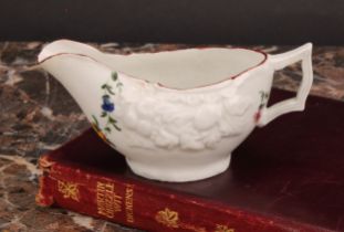 A Cookworthy Bristol butter boat, moulded with fruit, painted with floral swag and sprays, 10.5cm