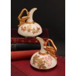 A pair of Royal Worcester ewers, of compressed form, decorated in the Aesthetic manner with